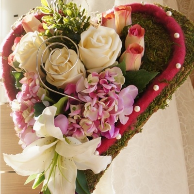 Hochzeit Kirchenschmuck, Moosherz auf Ständer floristisch mit Rosen, Hortensien und Lilien in rosa weiß dekoriert.